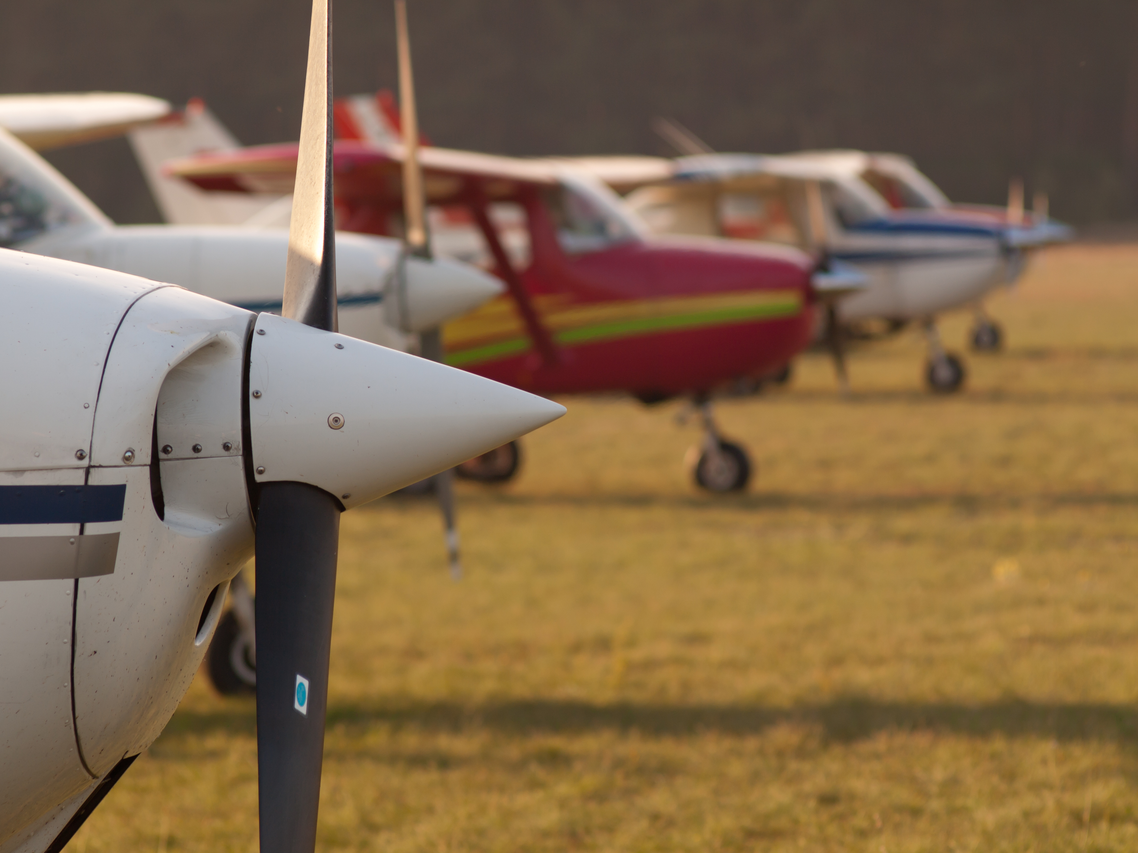 An image of multiple light aviation aircraft on a green background