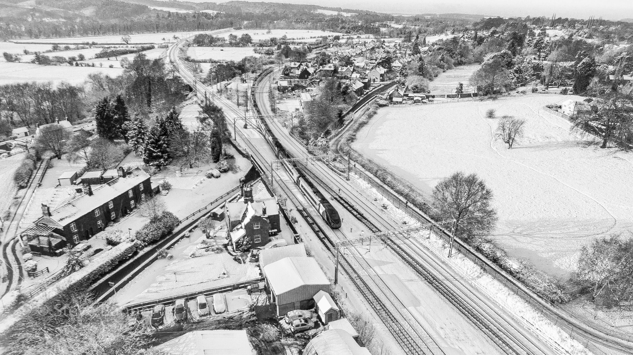 photo of a train in the snow taken by drone